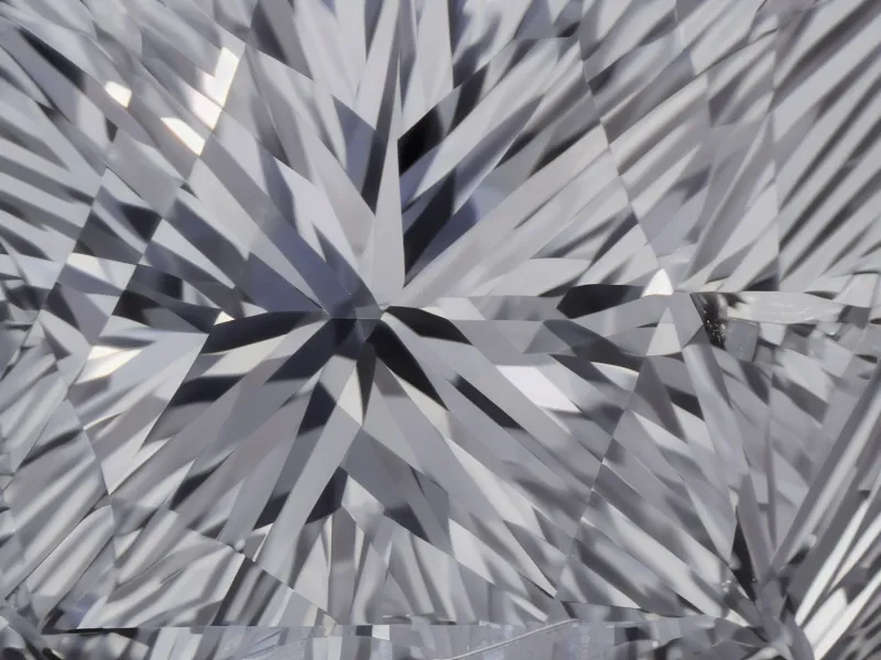 Lab-grown princess cut diamond with clean clarity displayed in a jeweler's tray